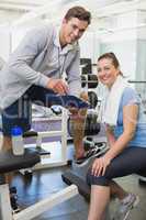 Personal trainer and client looking at clipboard together