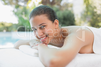 Beautiful woman lying on massage table at spa center