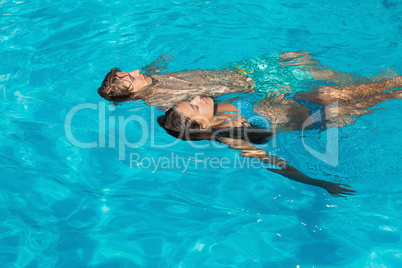 Relaxed young couple in swimming pool