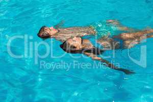 Relaxed young couple in swimming pool
