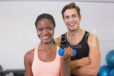 Personal trainer and client smiling at camera