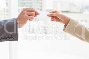 Close-up of hands holding business card