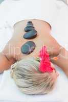 Woman receiving stone massage at health farm