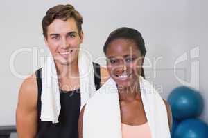 Personal trainer and client smiling at camera