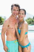 Romantic couple by swimming pool on a sunny day