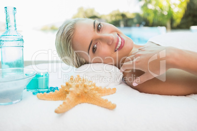 Beautiful woman lying on massage table at spa center