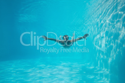 Young man swimming underwater