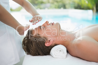 Handsome man receiving treatment at spa center