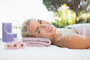 Beautiful woman lying on massage table at spa center