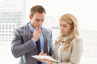 Businessman and secretary looking at diary