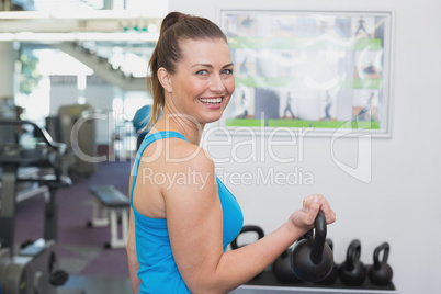 Fit brunette working out with kettlebell