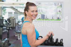 Fit brunette working out with kettlebell