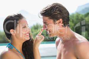 Romantic young couple by swimming pool