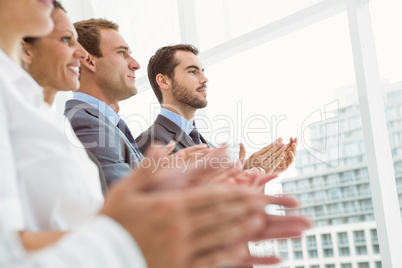 Business people clapping hands in office
