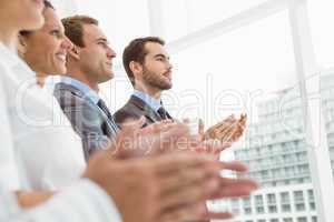 Business people clapping hands in office