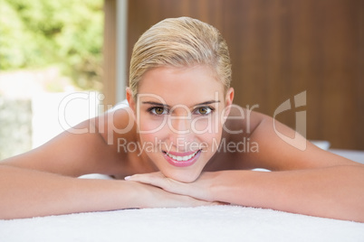 Beautiful woman lying on massage table at spa center