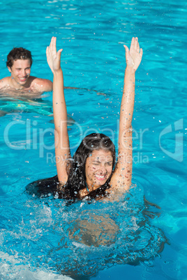 Couple playing in swimming pool