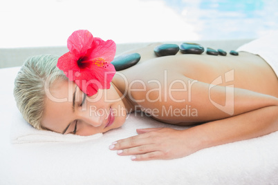 Beautiful woman receiving stone massage at health farm Beautiful woman receiving stone massage at health farm