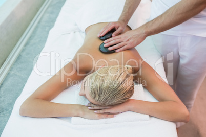 Woman receiving stone massage at health farm