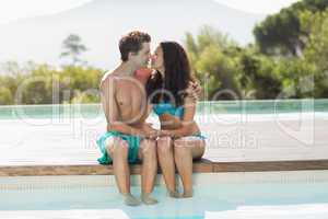 Romantic young couple by swimming pool