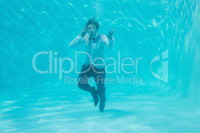 Young man swimming underwater