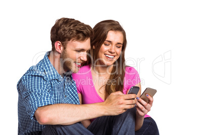 Cheerful couple with mobile phones