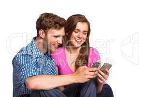Cheerful couple with mobile phones