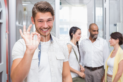 Happy businessman making okay gesture