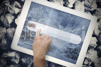 Hands touching search bar on tablet screen