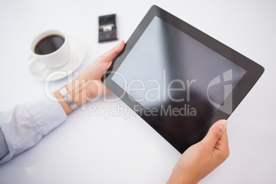 Businesswoman using tablet pc at her desk