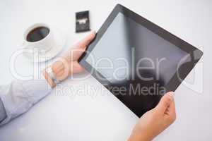 Businesswoman using tablet pc at her desk