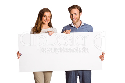 Happy young couple with blank board