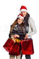 Happy couple in santas hats with gifts