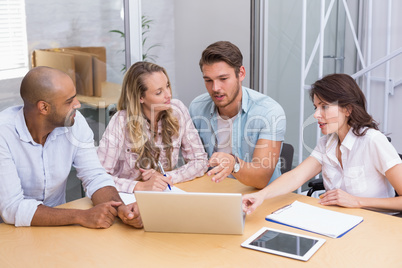 Group of business people using tablet computer and laptop