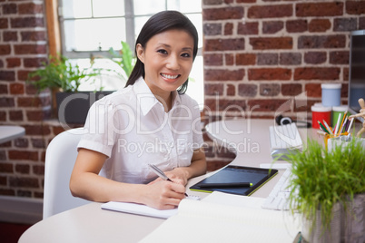 Casual designer working at her desk