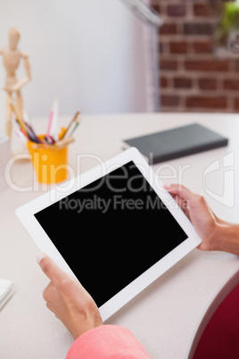 Casual businesswoman using tablet pc