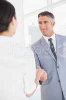 Businessman shaking co workers hand