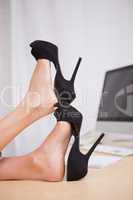 Businesswoman with high heels on desk