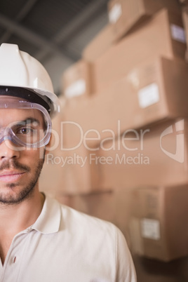 Close up of worker wearing hard hat in warehouse