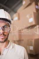 Close up of worker wearing hard hat in warehouse