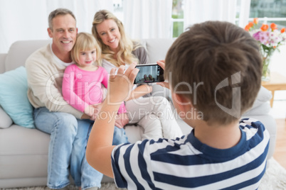 Son taking a photo of his family