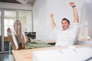 Cheerful businessman cheering in office