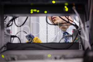 Technician using digital cable analyzer on server