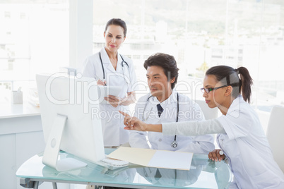 Doctors looking at the computer monitor