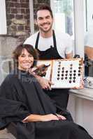 Pretty brunette picking out hair colour with stylist