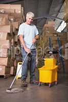 Man moping warehouse floor