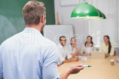 Smiling businessman giving presentation to his colleagues