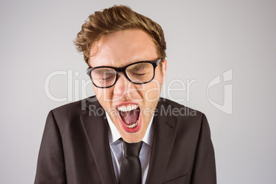 Young angry businessman shouting at camera