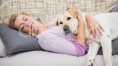 Beautiful blonde on couch with pet dog