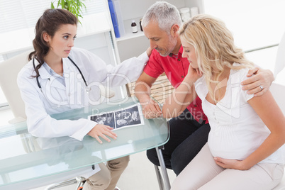 Doctor and nervous patient examining ultrasound